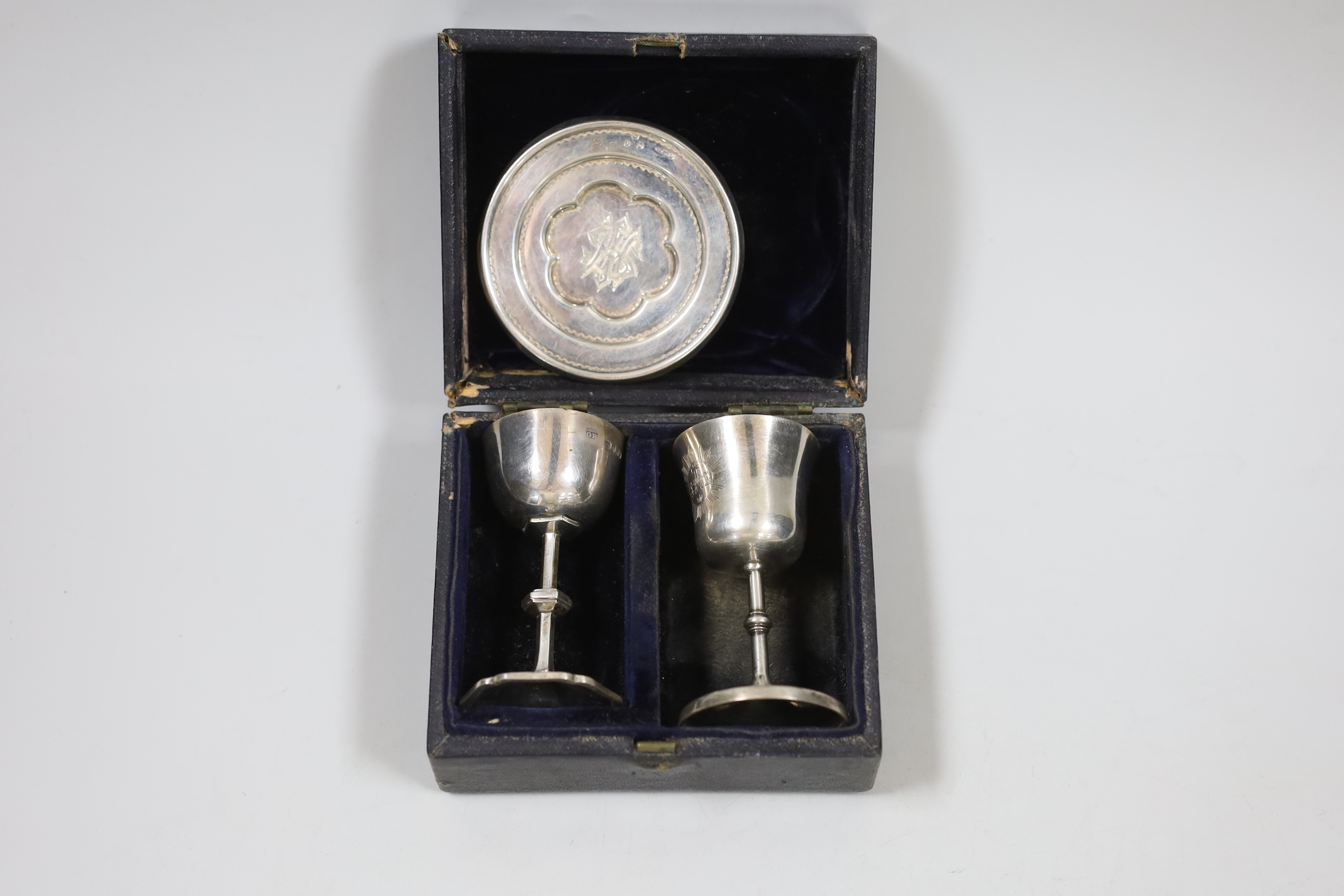 A cased matched Victorian silver travelling communion set, London, 1846, London, 1890 and Birmingham, 1850, tallest piece 78mm.
